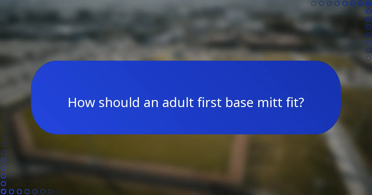 How should an adult first base mitt fit?